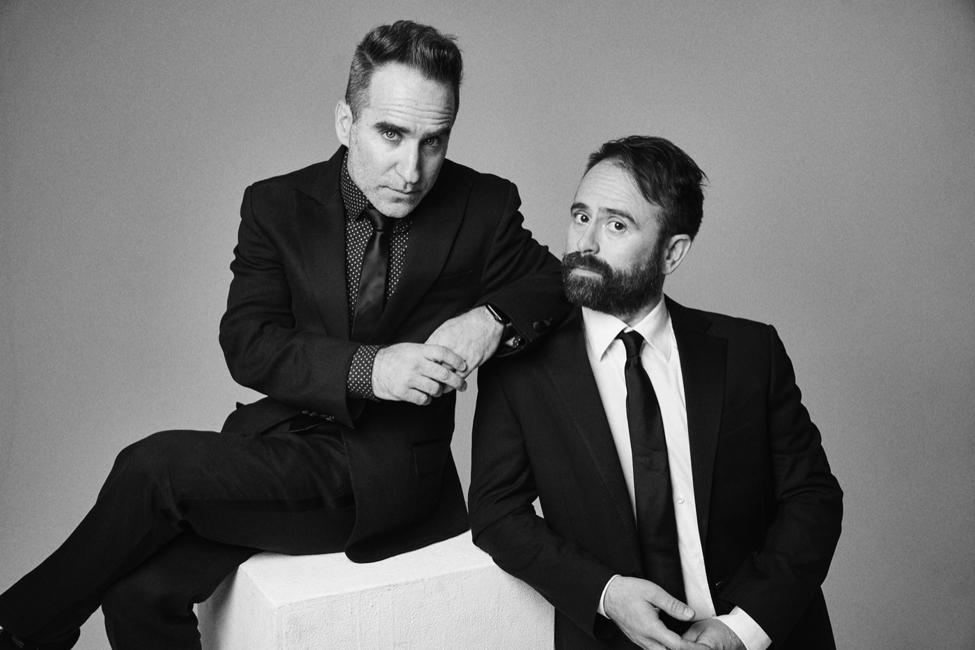 Ben Giroux and Arnie Pantoja seated together in black tie