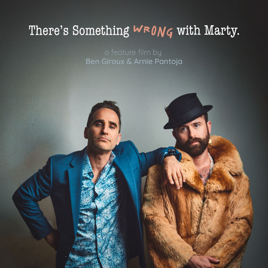 Two men from the poster artwork, one in a blue suit and one in a fur coat and hat