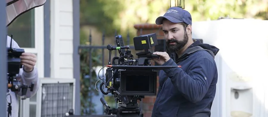 A Small Red Cape camera operator working with a cinema camera