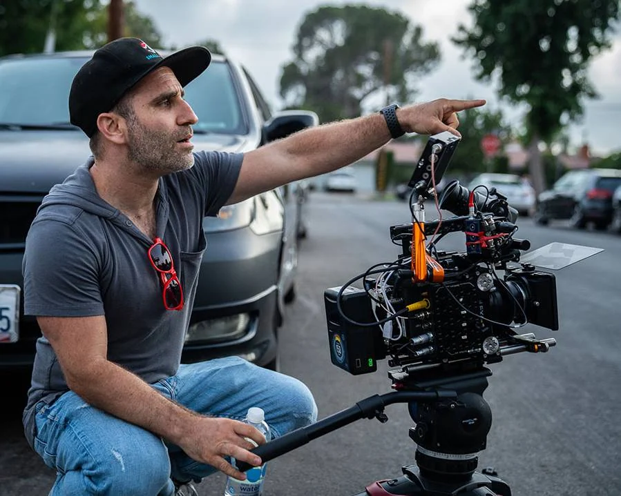 Ben Giroux directing beside a cinema camera