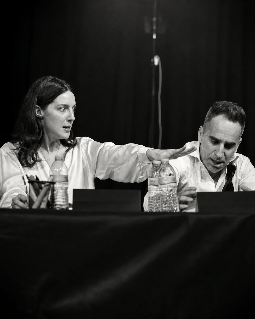 Two performers in character during the table read