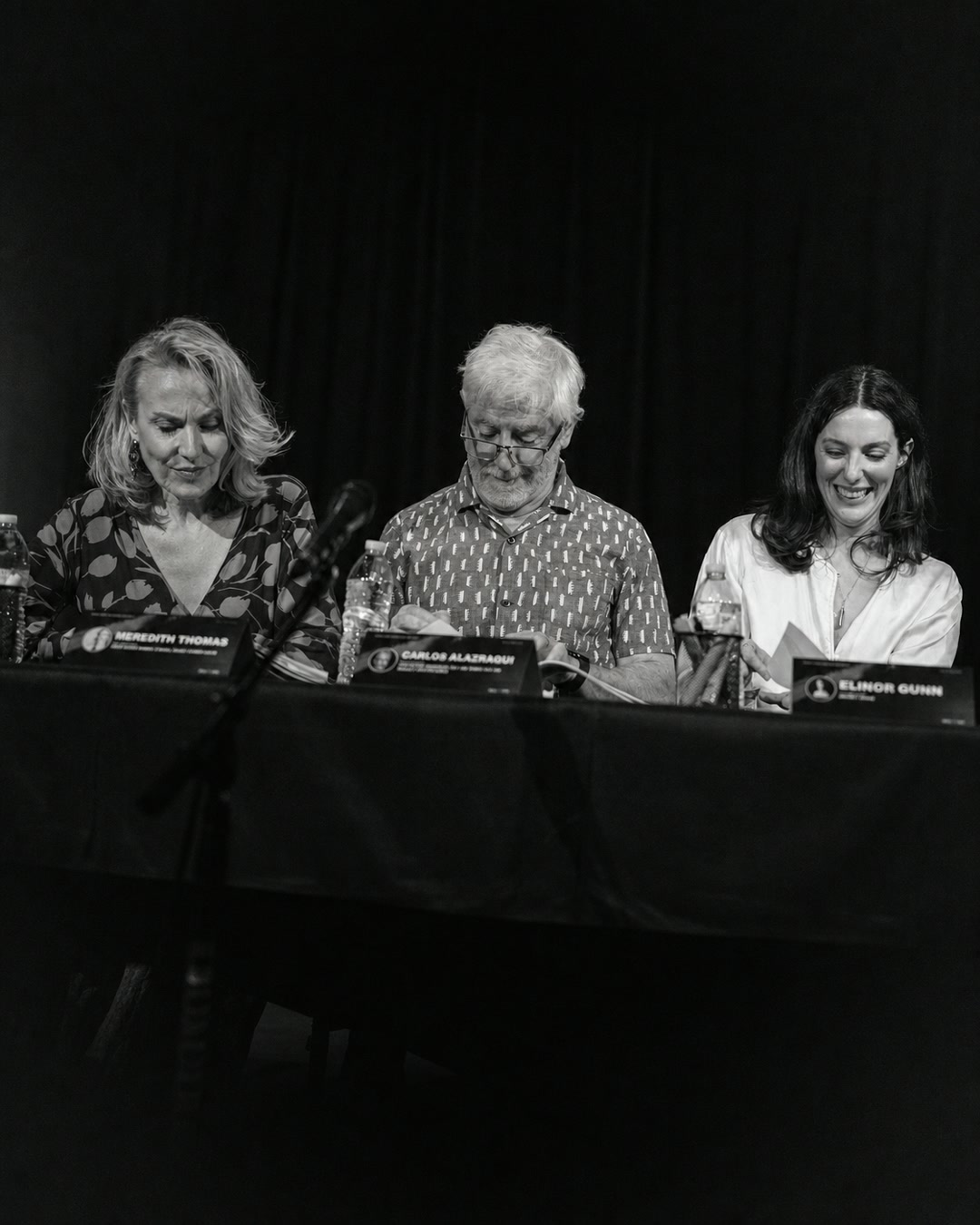Members of the ensemble performing together at the table read