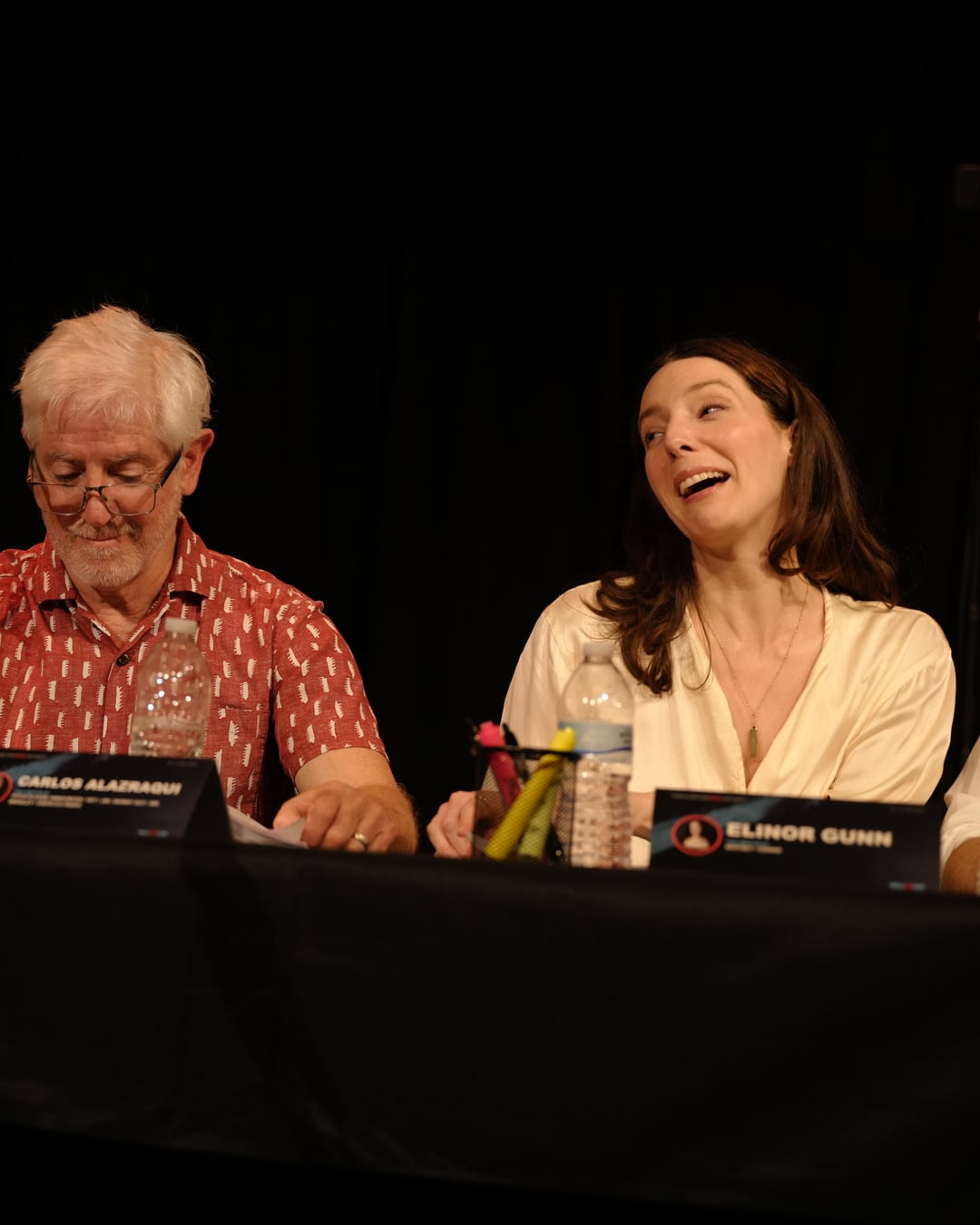 Cast members laughing together during the table read