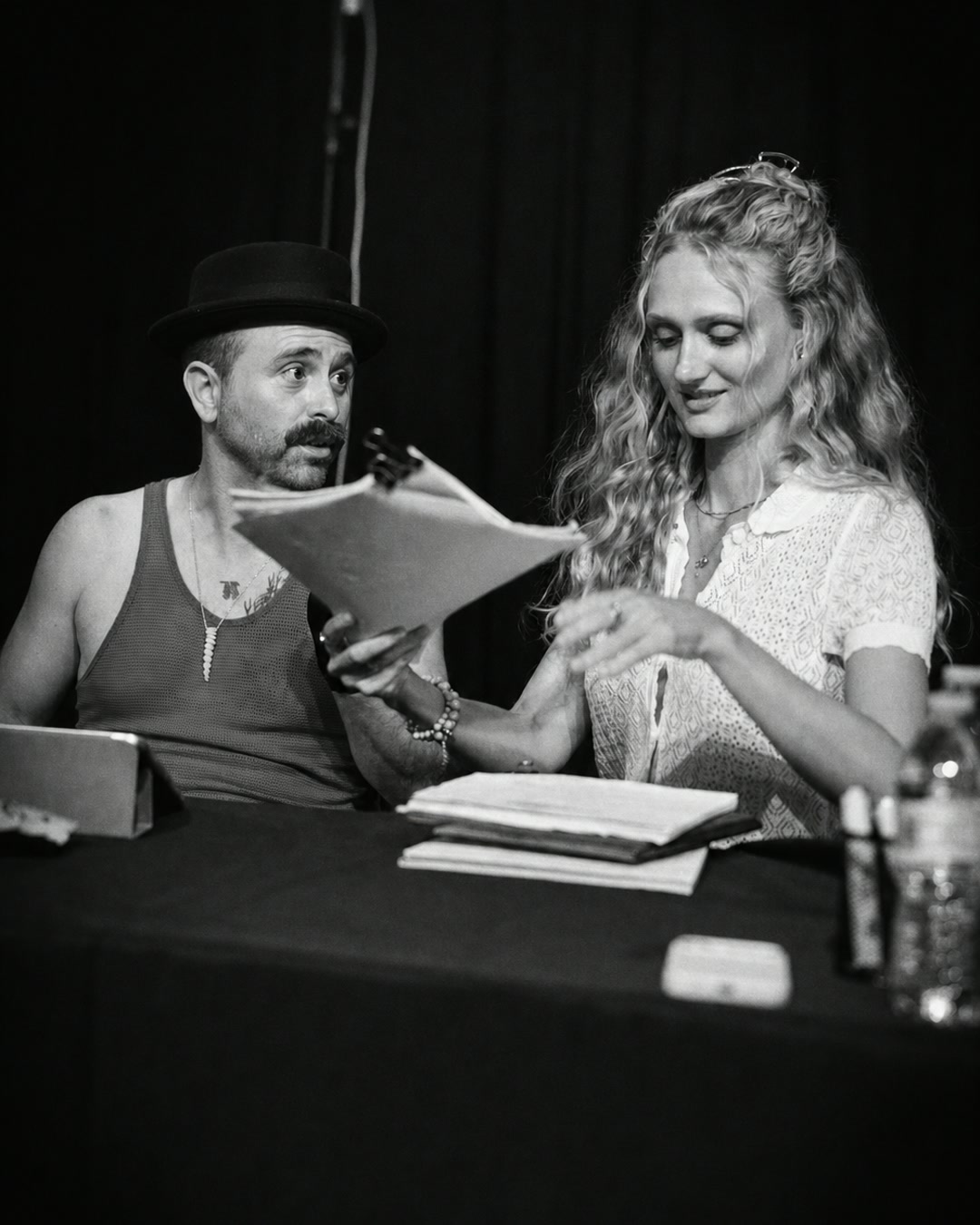 Arnie Pantoja and a castmate reading together onstage