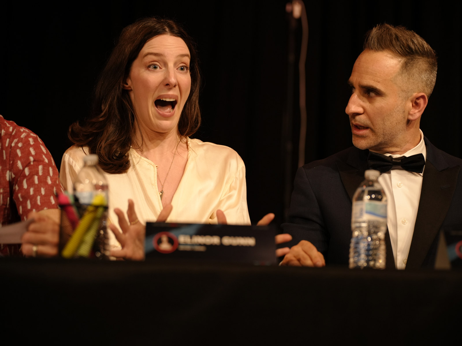 Two performers reacting together during the table read