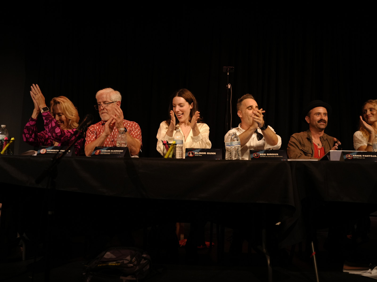 Cast members applauding together during the table read