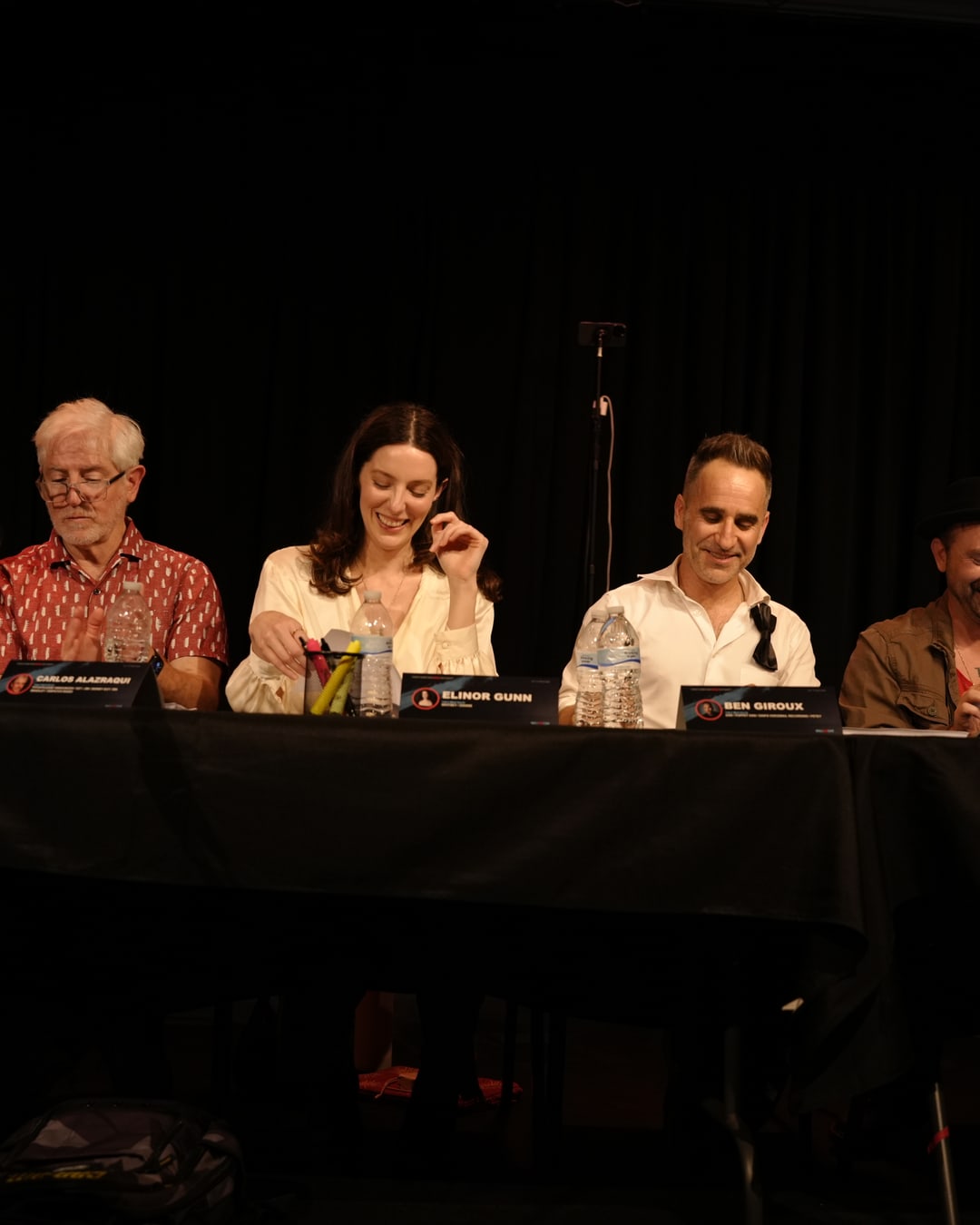The cast smiling together during the table read