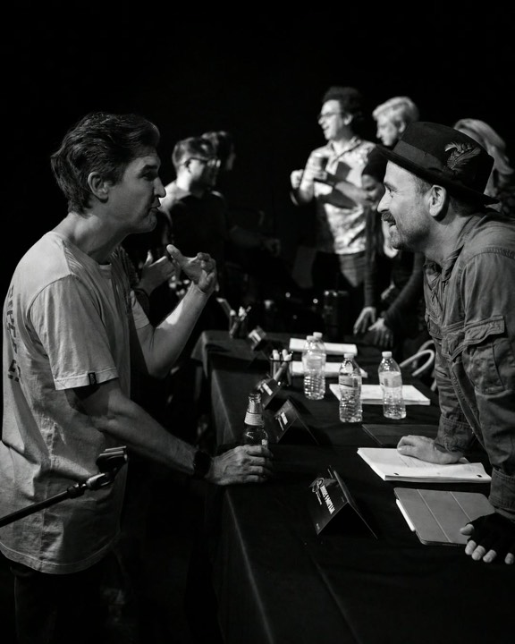 The creative team in conversation at the table read