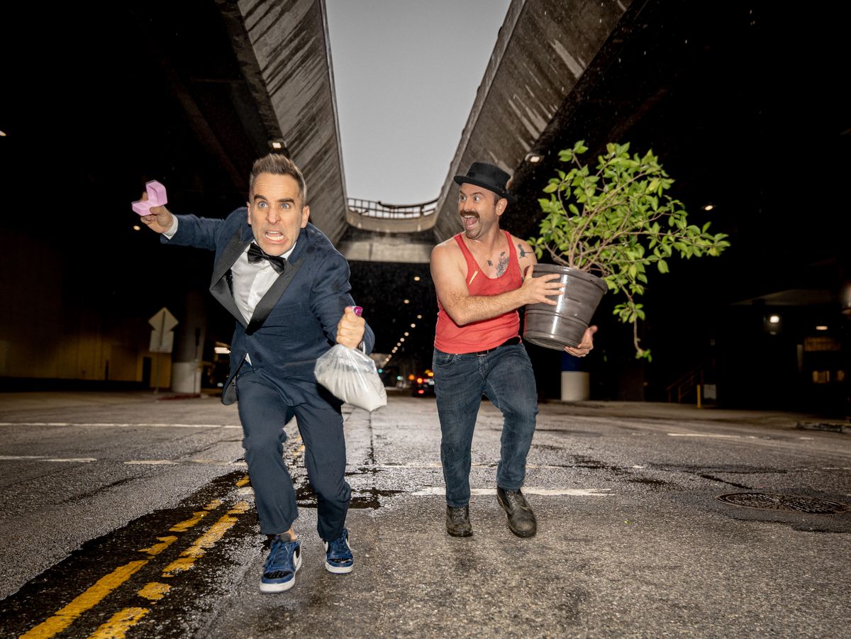 Ben Giroux and Arnie Pantoja running down a tunnel road at night