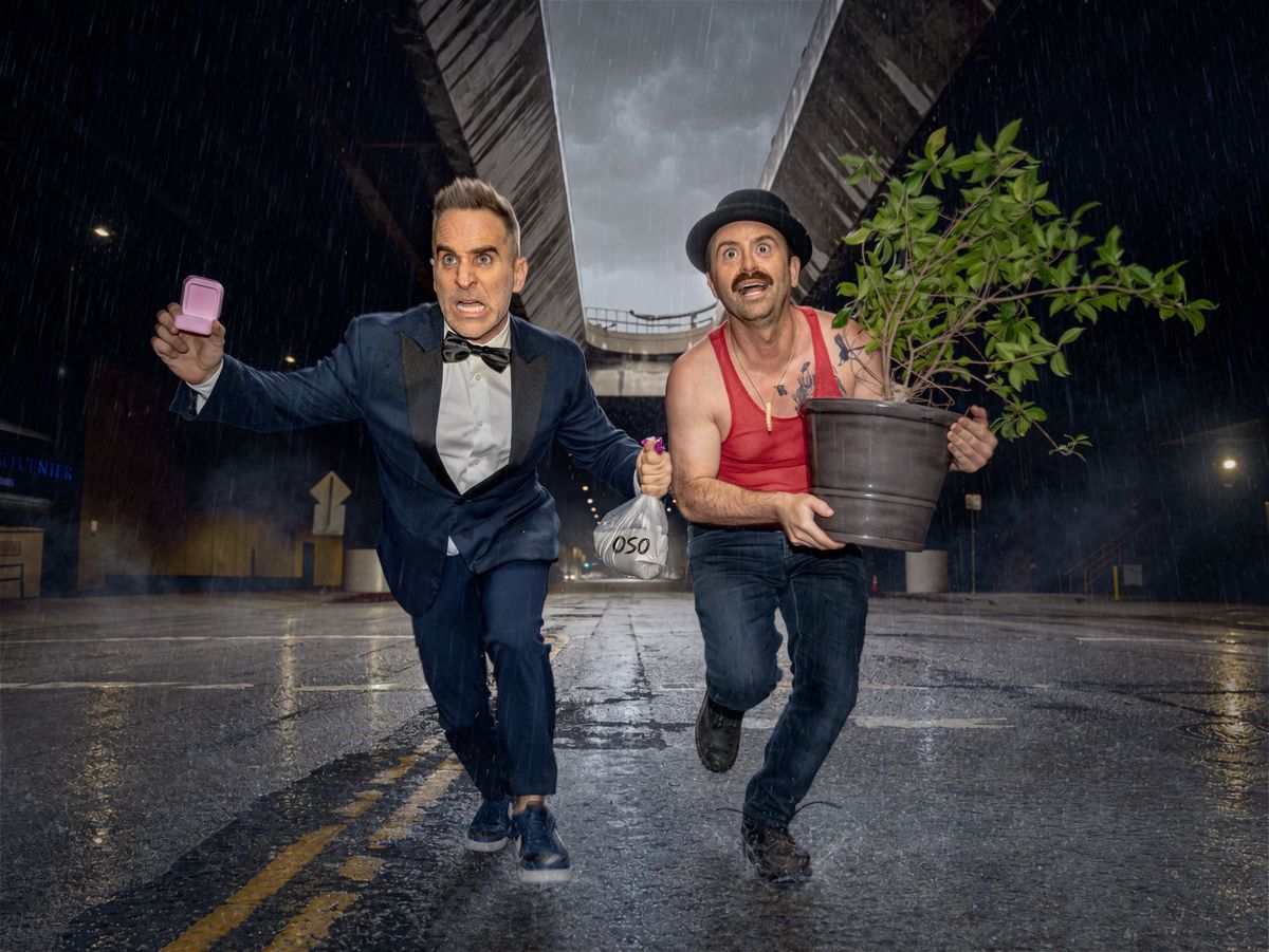 Ben Giroux as Dan and Arnie Pantoja as Marty running through a rain-soaked Los Angeles tunnel with a ring box, a bag of ashes and a potted plant