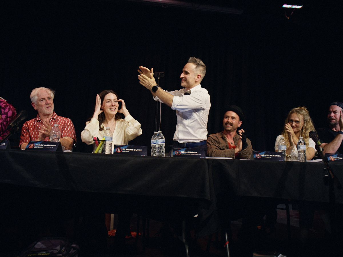 The cast at the July 12, 2026 table read, with Ben Giroux standing and applauding